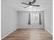 Spacious bedroom with wood flooring, a ceiling fan, and a large window at 10265 Gandy N Blvd # 1406, St Petersburg, FL 33702