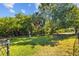 Community dog park featuring a grassy area with trees and fencing for safe playtime at 10265 Gandy N Blvd # 1406, St Petersburg, FL 33702