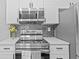 The kitchen features modern appliances, sleek countertops, and stylish backsplash at 10265 Gandy N Blvd # 1406, St Petersburg, FL 33702