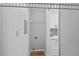 Laundry room featuring space-saving shelving next to modern kitchen at 10265 Gandy N Blvd # 1406, St Petersburg, FL 33702