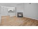Bright living room featuring wood floors, a fireplace, and an open floor plan to kitchen at 10265 Gandy N Blvd # 1406, St Petersburg, FL 33702
