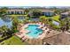 Aerial view of a community pool surrounded by palm trees and patio furniture at 10265 Gandy N Blvd # 1406, St Petersburg, FL 33702