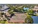 Aerial view of tennis courts next to a lake at 10265 Gandy N Blvd # 1406, St Petersburg, FL 33702