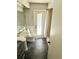 Bathroom featuring a vanity, commode, and shower with updated grey tile flooring at 11272 Portsmouth St, Spring Hill, FL 34609