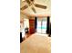 Bright bedroom with hardwood floors, closet, and sliding glass doors to screened-in pool at 11272 Portsmouth St, Spring Hill, FL 34609