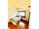 Cozy bedroom featuring wood floors, a ceiling fan, and a window offering natural light at 11272 Portsmouth St, Spring Hill, FL 34609