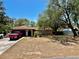 Charming single story home with mature trees, front lawn, and an attached two-car garage at 11272 Portsmouth St, Spring Hill, FL 34609