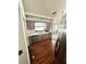 Galley-style kitchen with wood cabinets, wood floors, and stainless steel appliances at 11272 Portsmouth St, Spring Hill, FL 34609