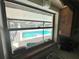 Window view of the backyard pool with a patio area, perfect for relaxing and entertaining at 11272 Portsmouth St, Spring Hill, FL 34609