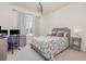 Cozy bedroom with a large window, desk, comfortable bed, and neutral decor at 11938 Bahia Valley Dr, Riverview, FL 33579