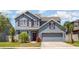 Charming two-story home with a well-manicured lawn, beautiful exterior paint and a spacious two-car garage at 11938 Bahia Valley Dr, Riverview, FL 33579
