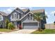 Stylish two-story house featuring a symmetrical facade, a two-car garage, and meticulously maintained landscaping at 11938 Bahia Valley Dr, Riverview, FL 33579