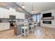 Modern kitchen with granite countertops, stainless steel appliances, an eat-in island, and a view to the fireplace at 11938 Bahia Valley Dr, Riverview, FL 33579