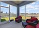 Screened lanai with cozy seating offers lovely view of backyard and surrounding neighborhood at 11938 Bahia Valley Dr, Riverview, FL 33579