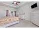Serene primary bedroom featuring a tray ceiling, dresser, and a view of the ensuite at 11938 Bahia Valley Dr, Riverview, FL 33579