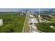 Aerial view of buildings, mangroves, a highway, and nearby waterways at 1237 Savona Ne Dr, St Petersburg, FL 33702