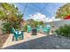 Relaxing backyard space featuring brick pavers, Adirondack chairs, and string lights at 1237 Savona Ne Dr, St Petersburg, FL 33702