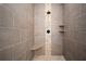 Sleek bathroom with a modern shower, pebble floor, and tiled walls at 1237 Savona Ne Dr, St Petersburg, FL 33702