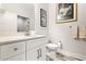 Bathroom featuring marble counters, white cabinets, and modern fixtures at 1237 Savona Ne Dr, St Petersburg, FL 33702