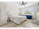 Light filled bedroom featuring a large window, a plush bed, and hardwood floors at 1237 Savona Ne Dr, St Petersburg, FL 33702