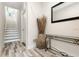 Inviting entryway with wood-look floors, a modern console table, and staircase at 1237 Savona Ne Dr, St Petersburg, FL 33702