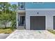 Inviting exterior features a private entry, single-car garage, and a well-maintained interlocking brick driveway at 1237 Savona Ne Dr, St Petersburg, FL 33702