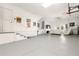 Spacious garage with painted floors, posters, basketball hoop, and an entertainment area at 1237 Savona Ne Dr, St Petersburg, FL 33702