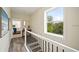 Upstairs hallway featuring wood floors, a large window, and an open doorway to a bedroom at 1237 Savona Ne Dr, St Petersburg, FL 33702