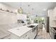 Modern kitchen featuring a large island, stainless steel appliances, and a barn door at 1237 Savona Ne Dr, St Petersburg, FL 33702