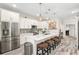Bright, open kitchen with white cabinets, quartz countertops, and a stylish backsplash at 1237 Savona Ne Dr, St Petersburg, FL 33702