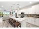 Modern kitchen featuring a large island, stainless steel appliances, and stylish bar stool seating at 1237 Savona Ne Dr, St Petersburg, FL 33702