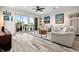 Open-concept living room with contemporary decor, hardwood floors, and a seamless transition to the outdoor space at 1237 Savona Ne Dr, St Petersburg, FL 33702