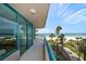 Private balcony with turquoise railings provides stunning ocean views and access to tropical landscaping at 1520 Gulf Blvd # 404, Clearwater, FL 33767