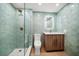 Contemporary bathroom with walk-in shower featuring stylish green tiling and glass door and modern fixtures at 1520 Gulf Blvd # 404, Clearwater, FL 33767