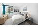 Bedroom with large window, side table, ocean view and white linens at 1520 Gulf Blvd # 404, Clearwater, FL 33767