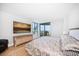 Bedroom with ocean view, dresser, large television, and hardwood floors at 1520 Gulf Blvd # 404, Clearwater, FL 33767