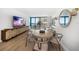 Stylishly decorated dining room featuring hardwood floors, modern furniture, and scenic views at 1520 Gulf Blvd # 404, Clearwater, FL 33767