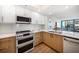 Bright kitchen features custom cabinets, stainless appliances, and white subway tile backsplash at 1520 Gulf Blvd # 404, Clearwater, FL 33767