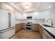 Kitchen featuring custom cabinets, stainless appliances, recessed lighting and light wood flooring at 1520 Gulf Blvd # 404, Clearwater, FL 33767