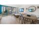 Bright living room featuring hardwood floors, modern furniture, and a beach view through the large window at 1520 Gulf Blvd # 404, Clearwater, FL 33767