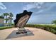 Outdoor sculpture near the beach with palm trees in the background and ocean views at 1520 Gulf Blvd # 404, Clearwater, FL 33767