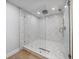 Shower features glass door, multiple shower heads, unique tile and a drain at 1520 Gulf Blvd # 404, Clearwater, FL 33767