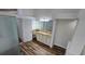 Bathroom featuring vanity area with lots of storage space, leading to a shower behind a frosted glass door at 15209 Arbor Hollow Dr, Odessa, FL 33556