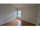 Bright bedroom featuring wood floors, a window with shutters, and a spacious closet at 15209 Arbor Hollow Dr, Odessa, FL 33556