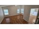 Bright bedroom with wood floors, vaulted ceiling, and shuttered windows, creating a cozy retreat at 15209 Arbor Hollow Dr, Odessa, FL 33556
