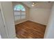 Cozy bedroom with vaulted ceilings, wood floors, and shuttered arched window at 15209 Arbor Hollow Dr, Odessa, FL 33556