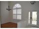 Bright entryway with stylish chandelier, wood floors and decorative glass front door at 15209 Arbor Hollow Dr, Odessa, FL 33556
