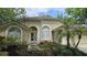Inviting front exterior showcasing a decorative window and landscaped garden at 15209 Arbor Hollow Dr, Odessa, FL 33556
