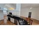 Spacious kitchen featuring black countertops, stainless steel appliances, and wood flooring at 15209 Arbor Hollow Dr, Odessa, FL 33556