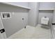 Functional laundry room with utility sink, shelving, and practical design at 15209 Arbor Hollow Dr, Odessa, FL 33556